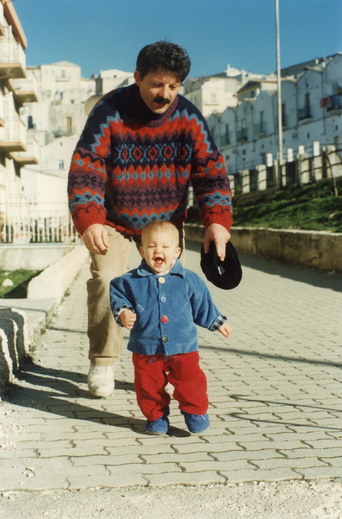 Francesco chasing Sarah outside their house in Monte