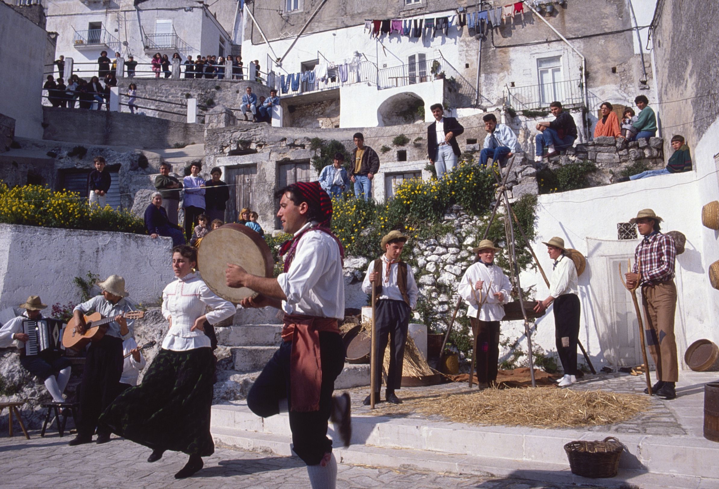 A group of musicians playing music and dancing the tarantella in the Junno in Monte Sant'Angelo