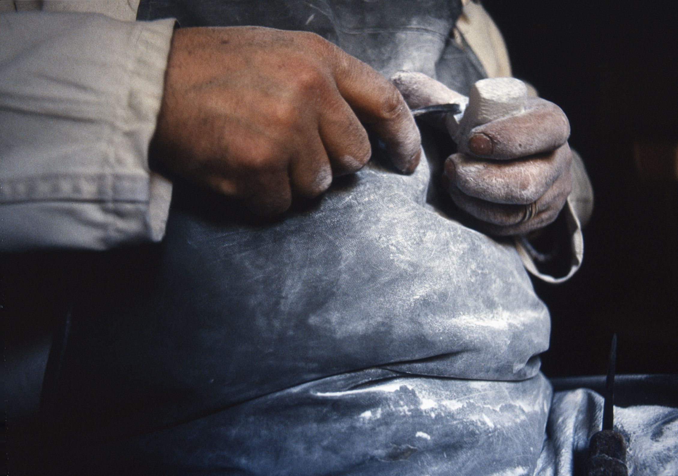 Mimo Palena sculpting a small statue of a pilgrim in his workshop in Monte Sant'Angelo