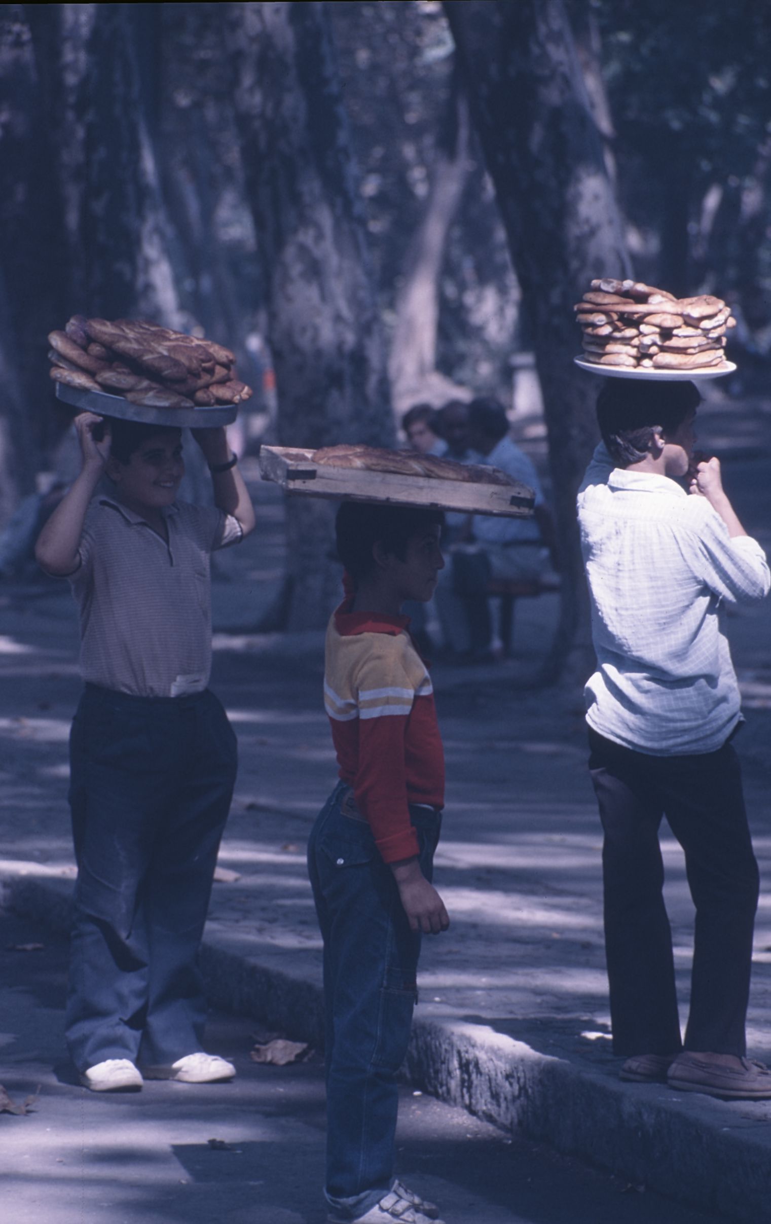 Three Turkish children with trays of bread in 1986